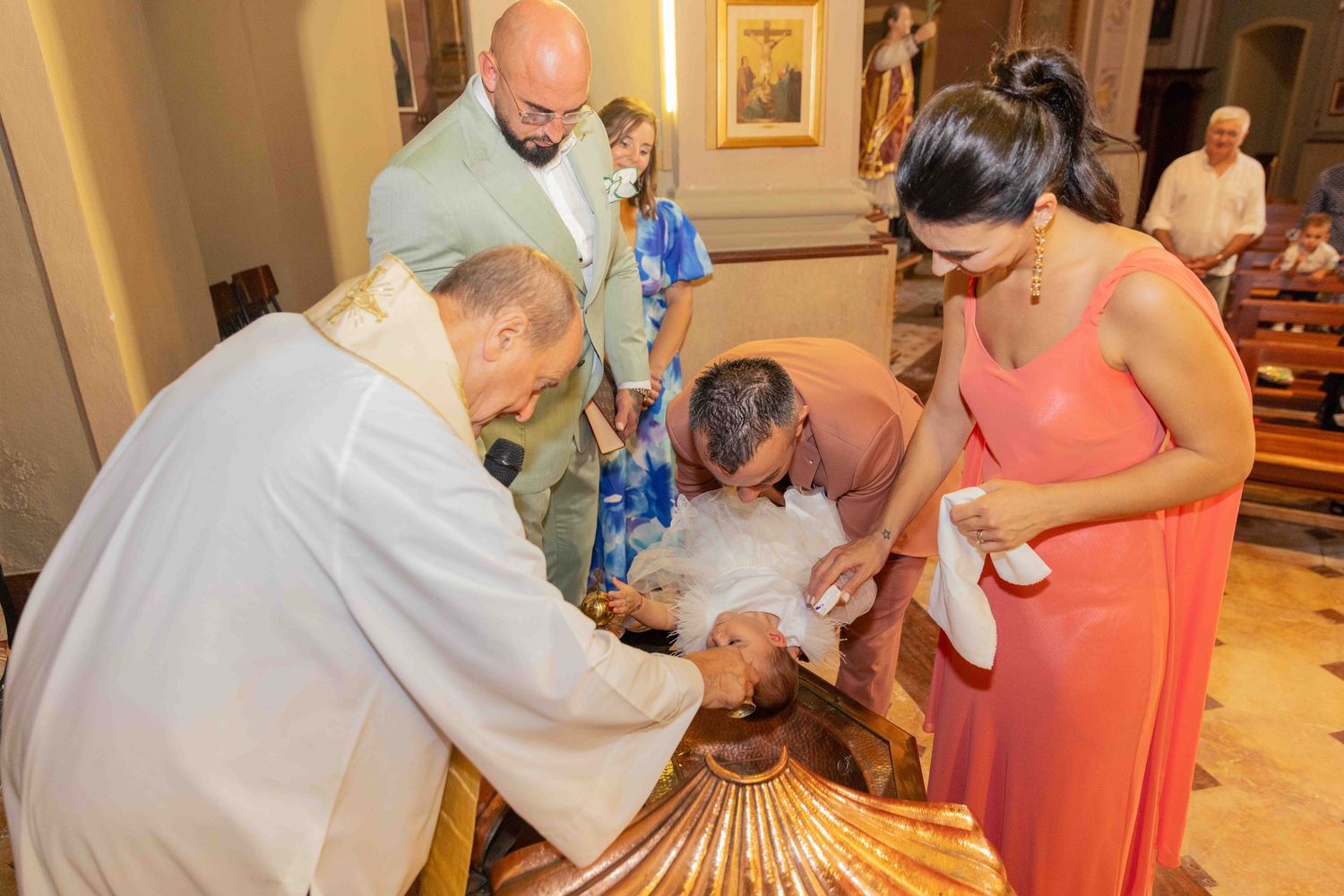 Wedding guests signing a guestbook at an elegant indoor reception venue.