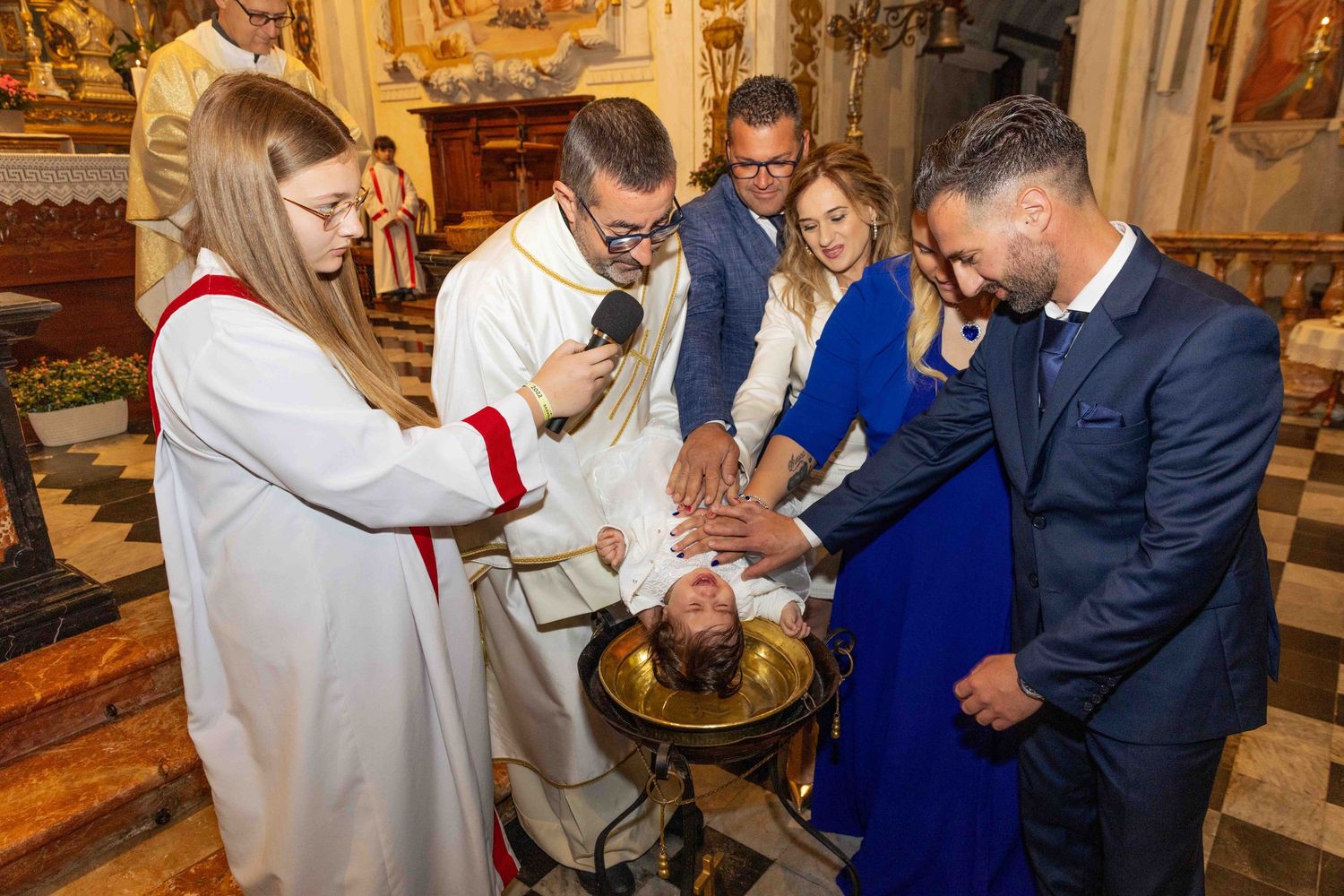 A series of photos showing a traditional religious baptism ceremony taking place inside an ornate church.