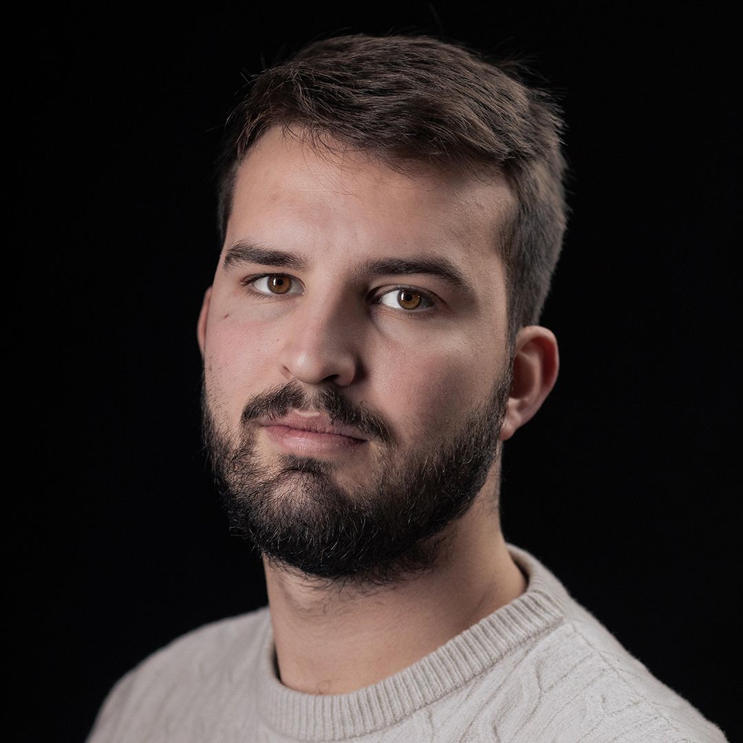 Portrait series showing bearded man in cream sweater against black background.