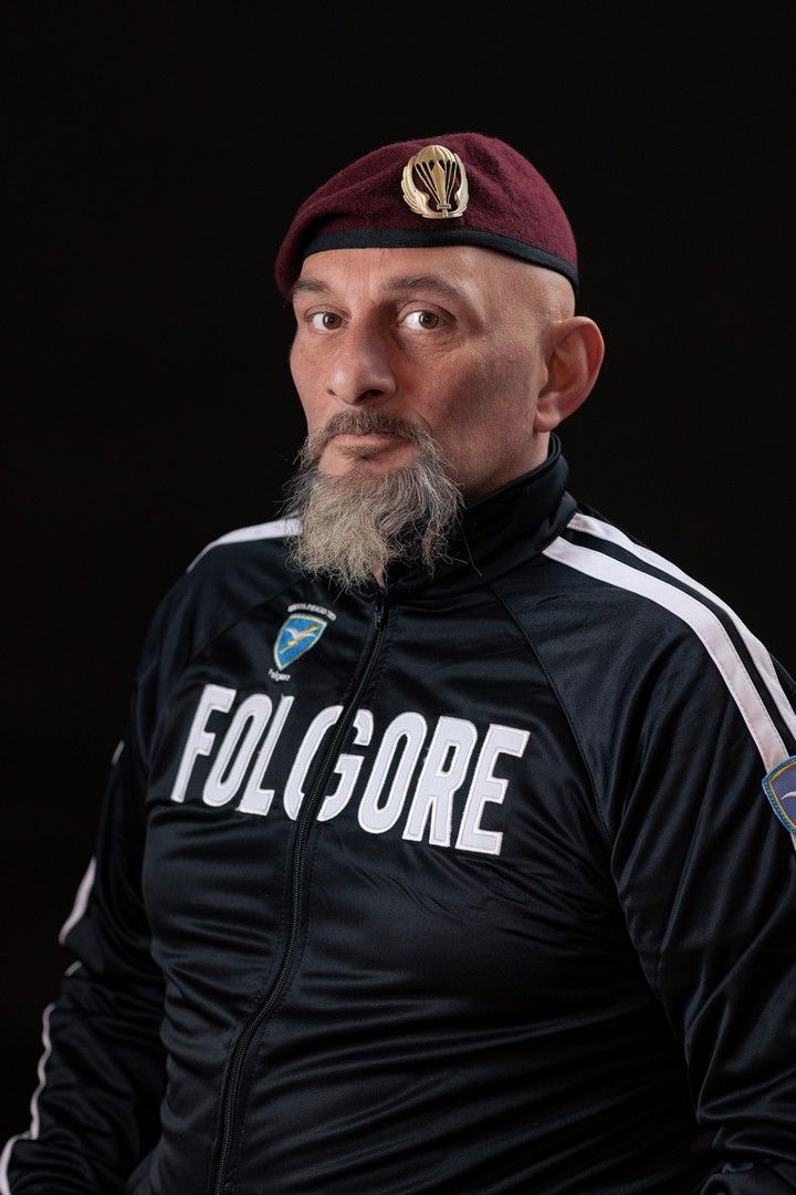 Portrait series of person wearing black athletic gear with 'Folklore' text against dark background.
