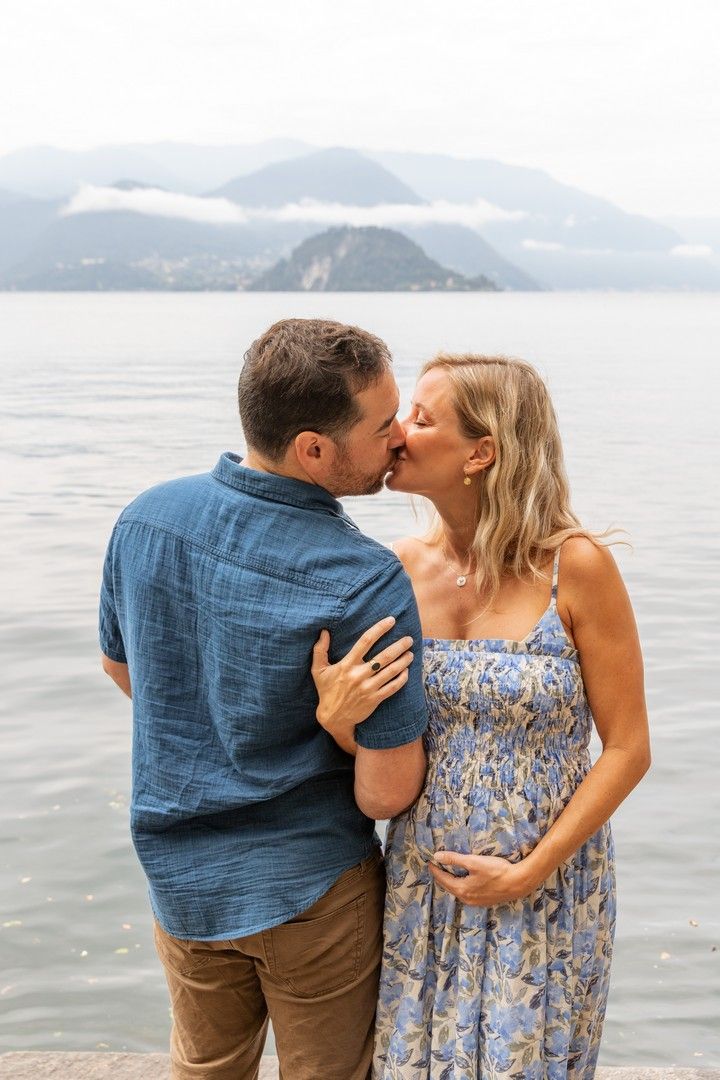 Intimate moments captured during lakeside pregnancy announcement photoshoot.