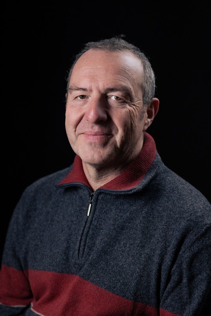 Portrait series showing person in two-tone fleece jacket against black background.
