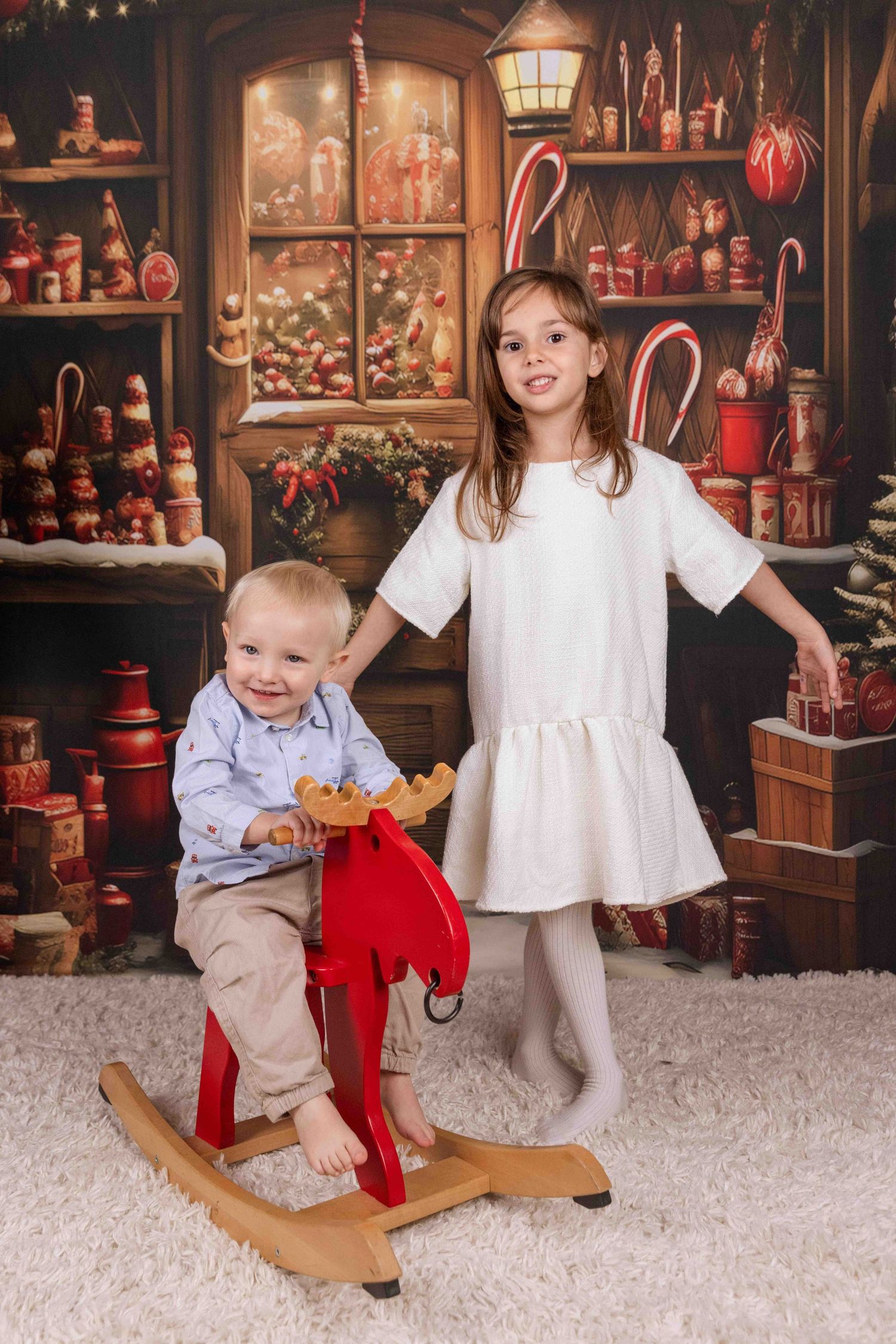 Vintage Christmas themed room with rocking horse and holiday decorations.