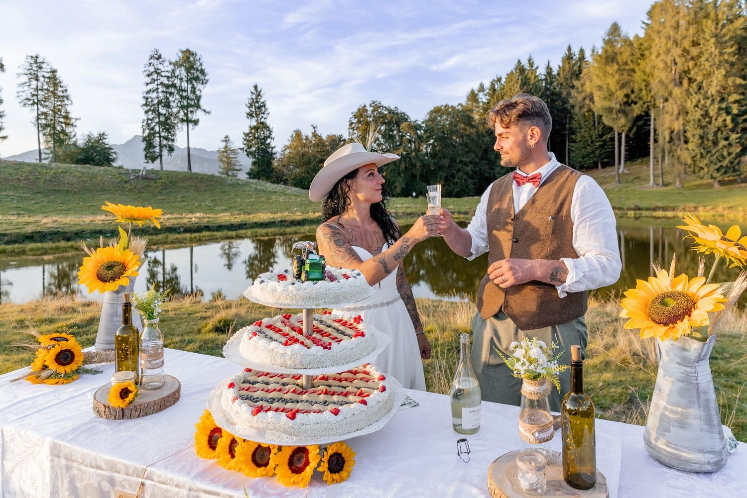 Wedding reception table decorated with sunflowers and rustic details outdoors.