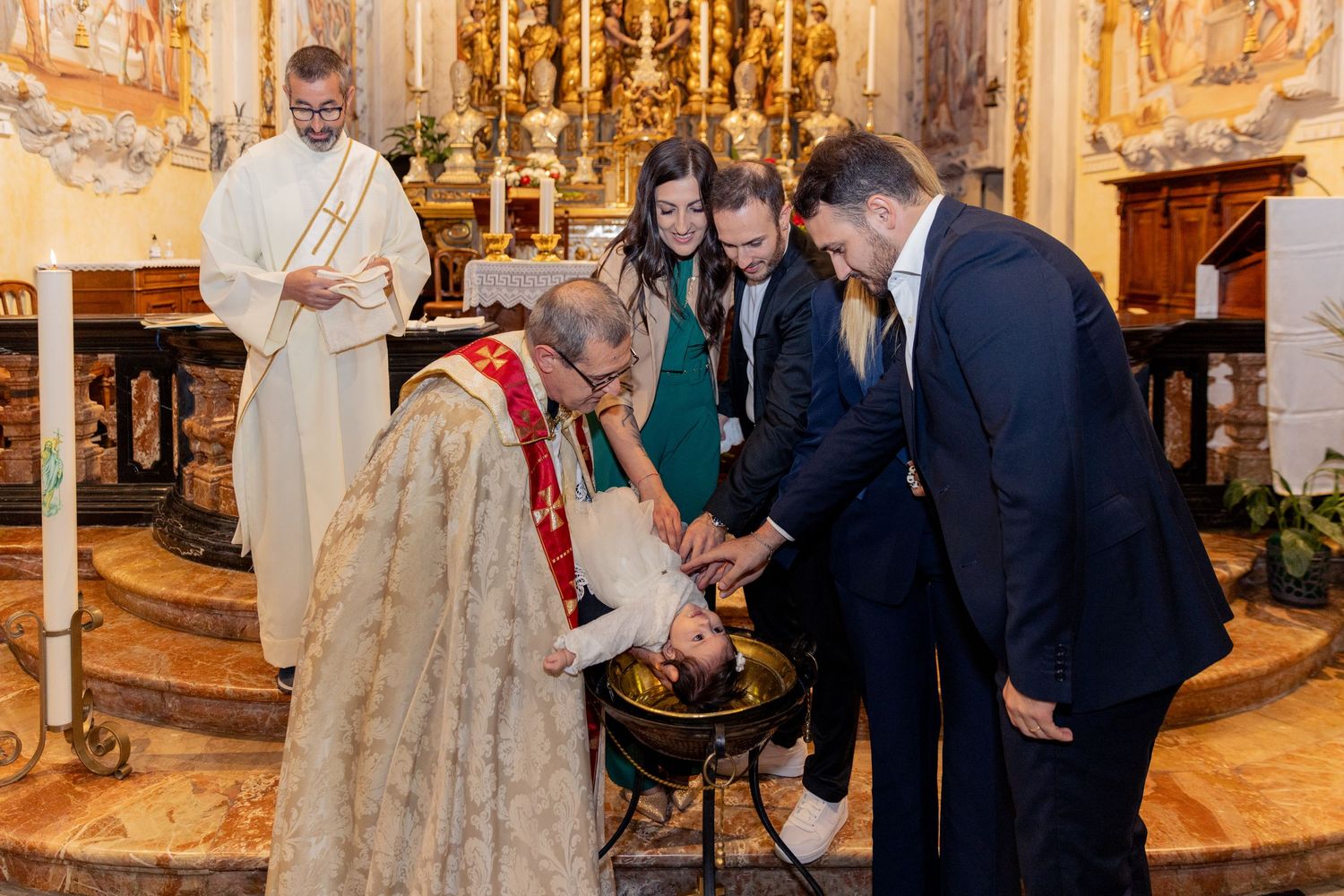 Ornate church interior with golden decorations during a formal ceremony.