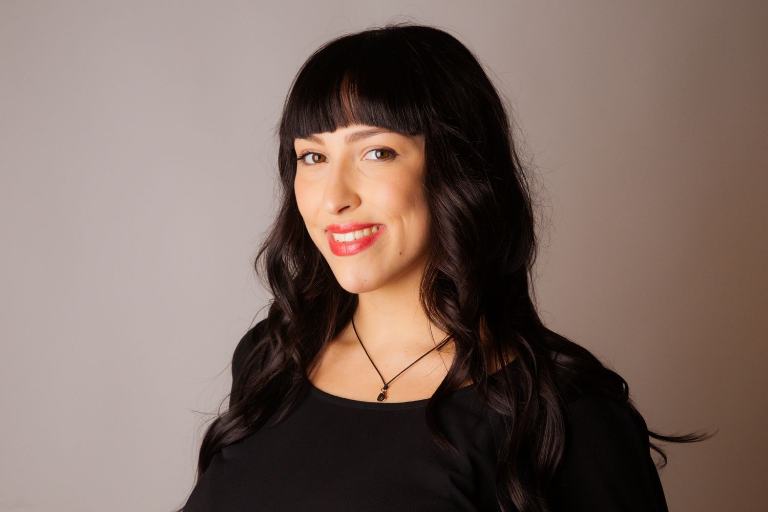 Studio portraits against neutral backdrop with dramatic lighting.