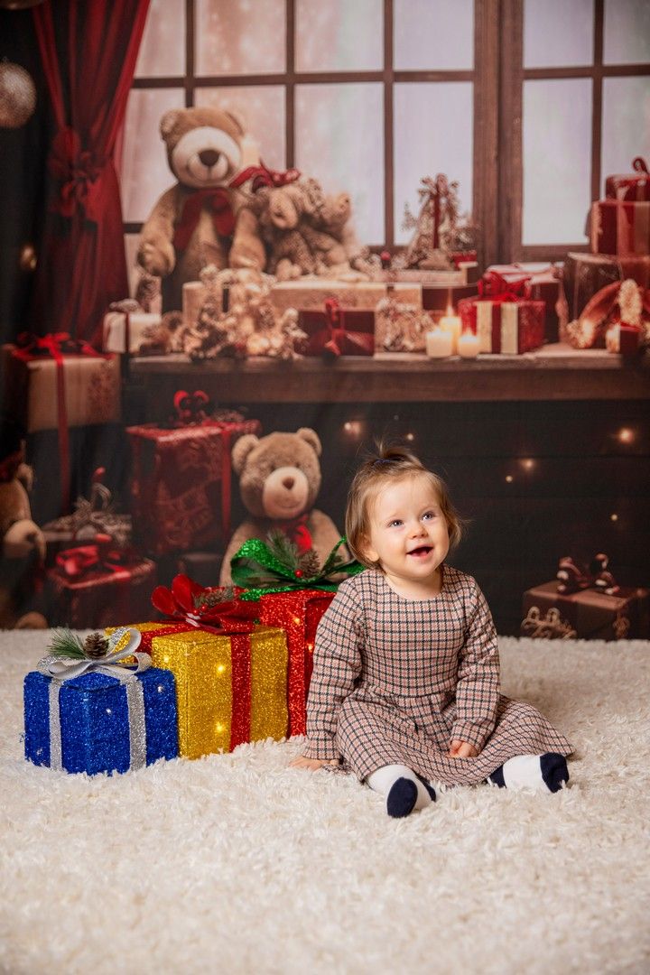 Festive holiday scene with wrapped presents and teddy bears in cozy indoor setting.