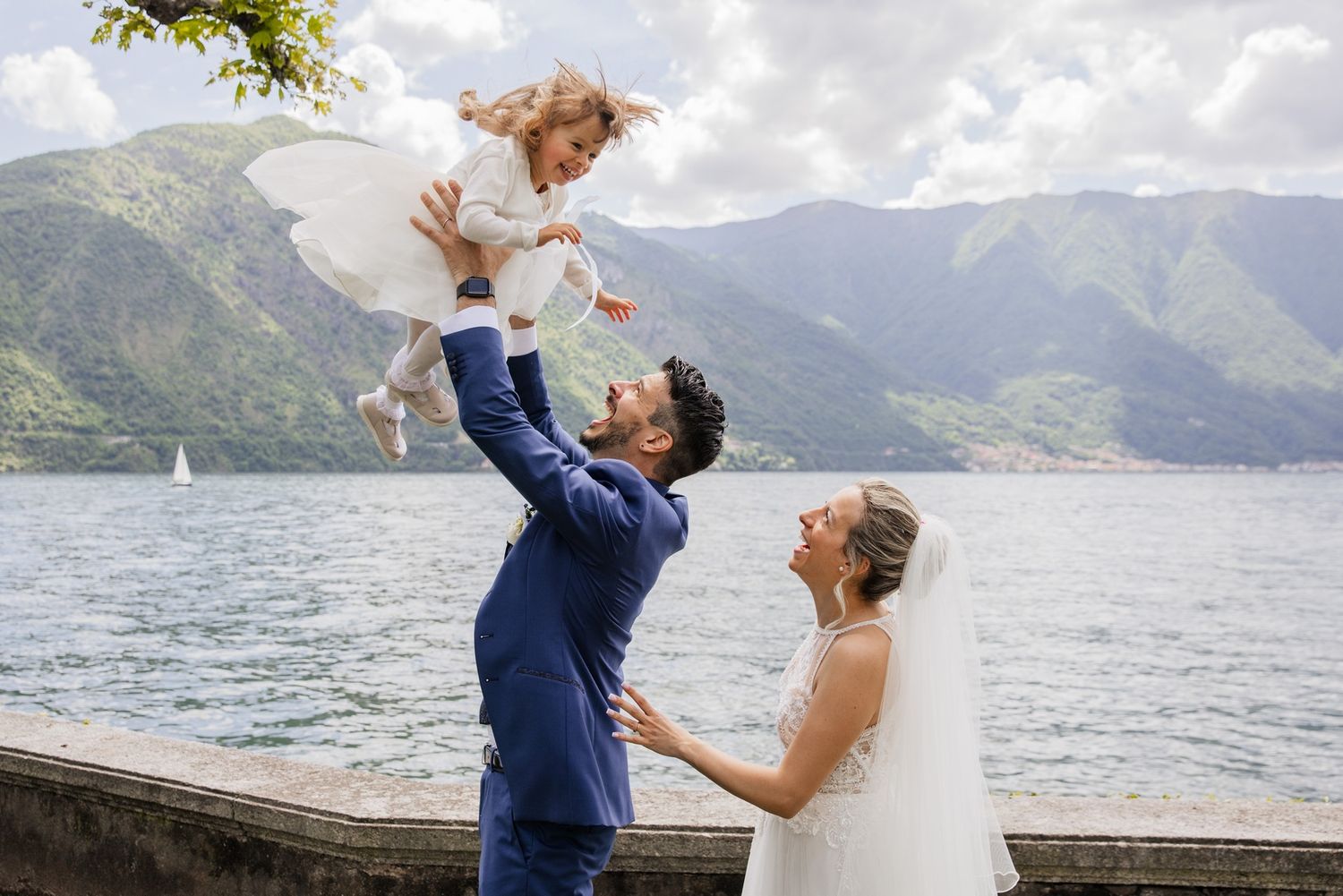 A series of romantic wedding moments captured by a lakeside with mountain views.