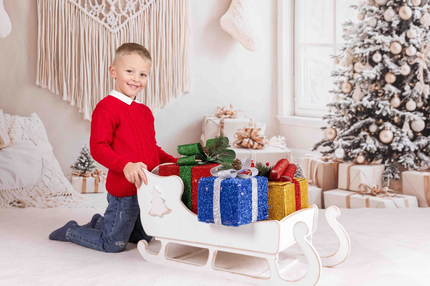 Holiday scene with decorated Christmas tree, wrapped presents, and white decor against neutral backdrop.