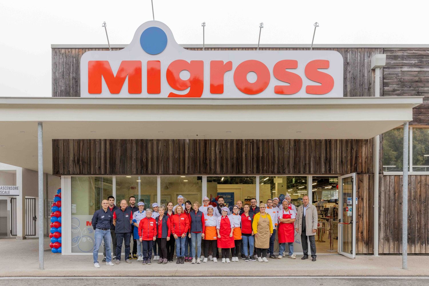 Exterior view of Migros retail store with red signage and storefront.
