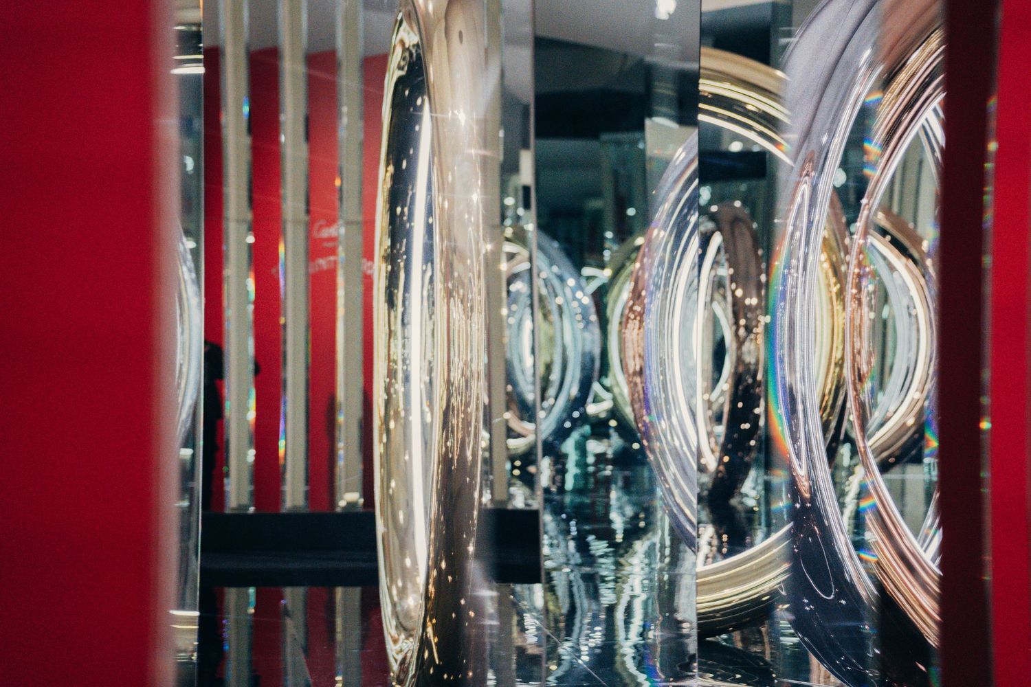 Crystal glassware and wine glasses sparkle on illuminated shelves in an elegant bar or restaurant display.