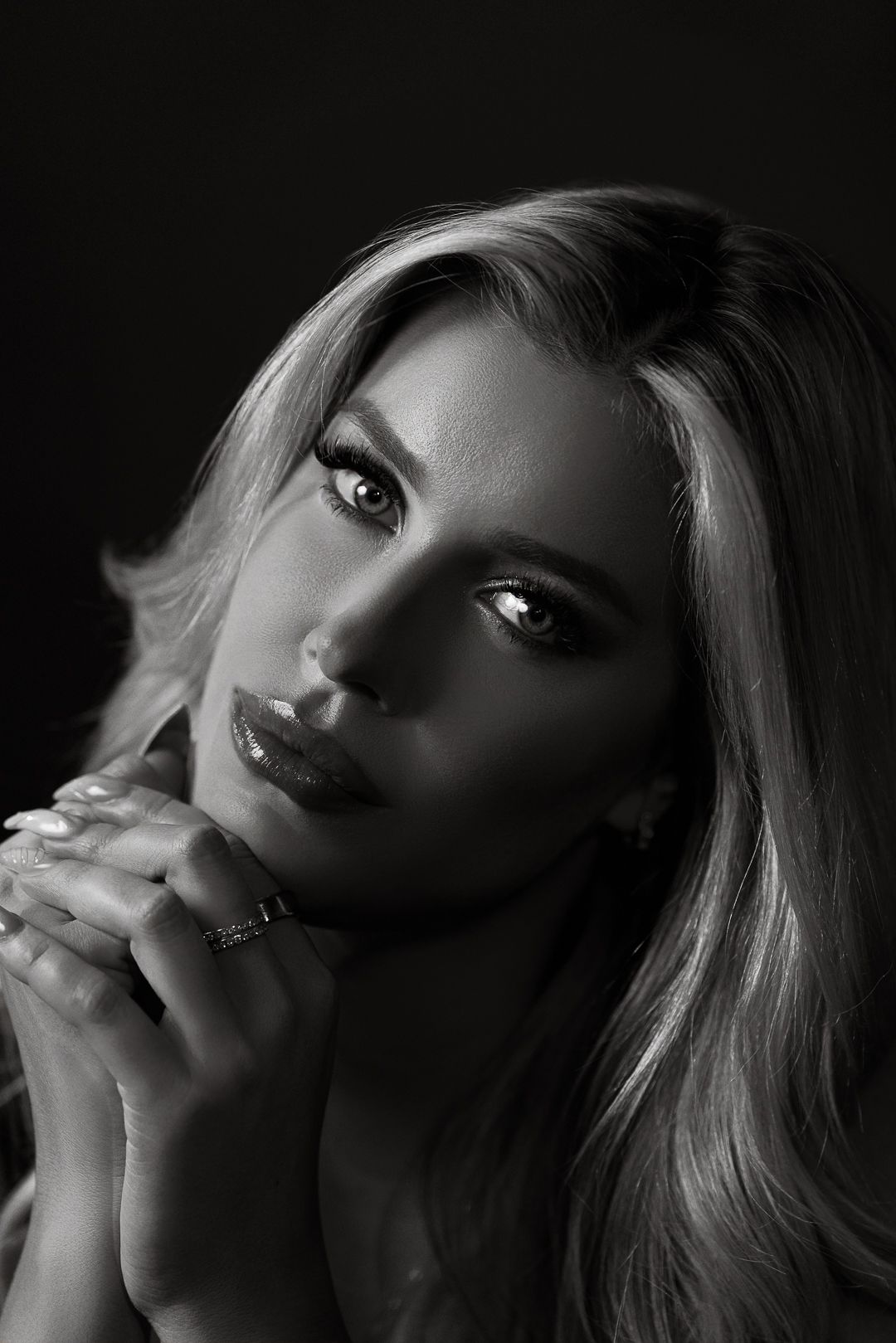Artistic black and white portrait series showing dramatic angles of a blonde woman in moody lighting.