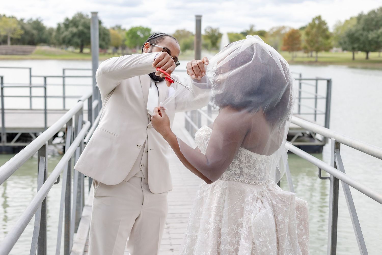 Romantic wedding photos showing couple on waterfront dock wearing elegant white dress and suit.