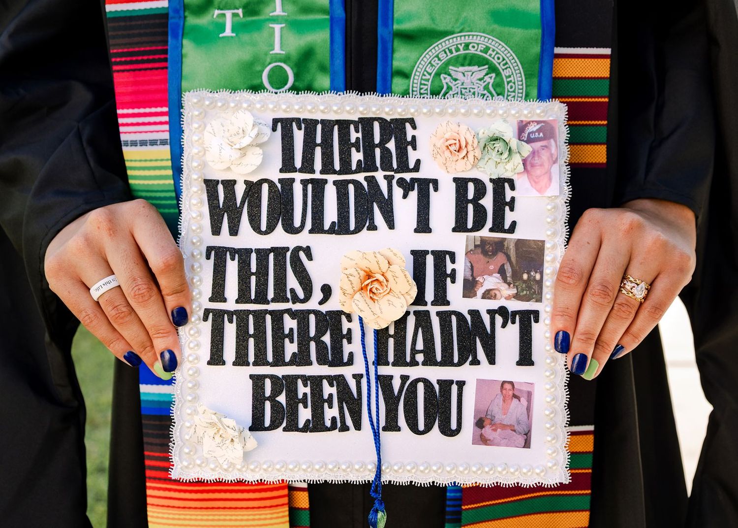 Close-up of decorated graduation cap reading There Wouldn't Be This If There Hadn't Been You with flowers and photos.