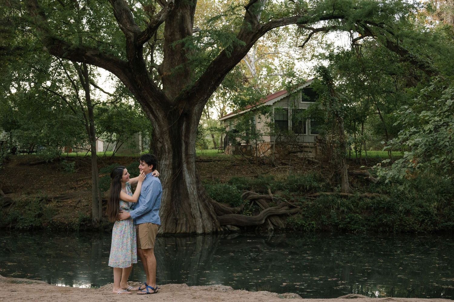 Sweet couple portraits under trees in a romantic outdoor garden setting.