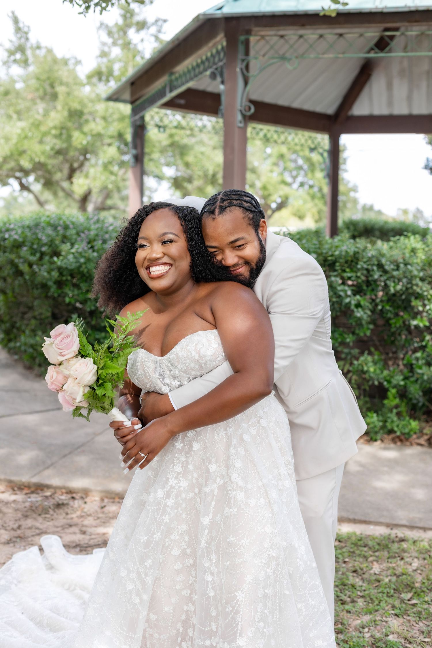 Joyful wedding photoshoot showing tender moments between couple in white attire.