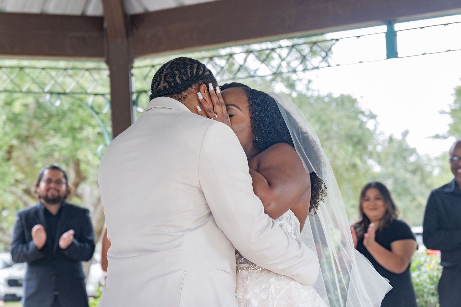 Emotional wedding celebration moment with guests in outdoor venue.