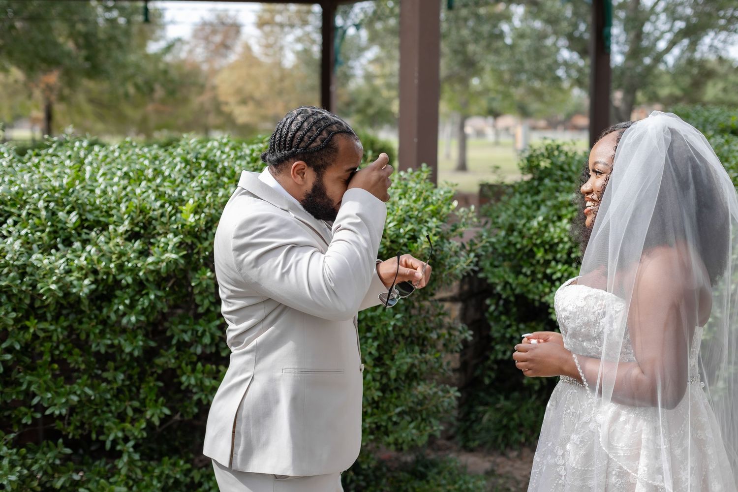 Sweet intimate wedding moment captured in a lush garden setting.