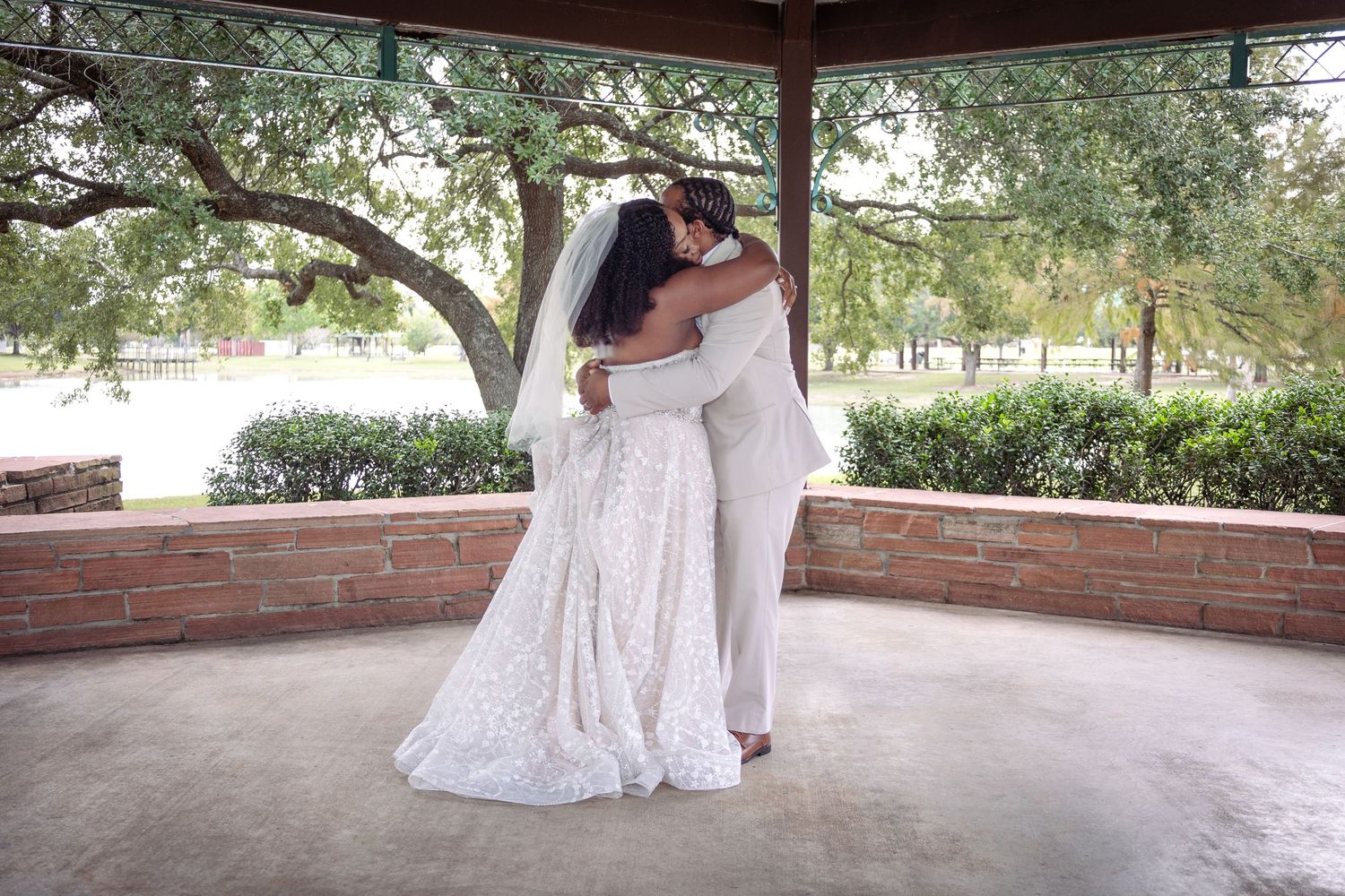 Wedding venue setting at a covered pavilion with lake views and natural surroundings.
