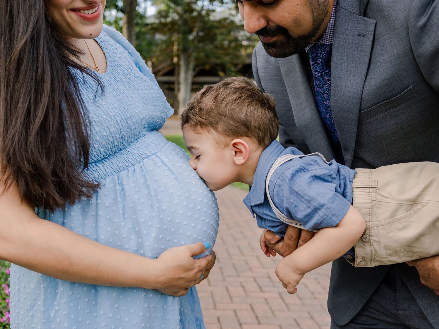 A family shares tender moments together in a series of candid photos on a brick walkway.