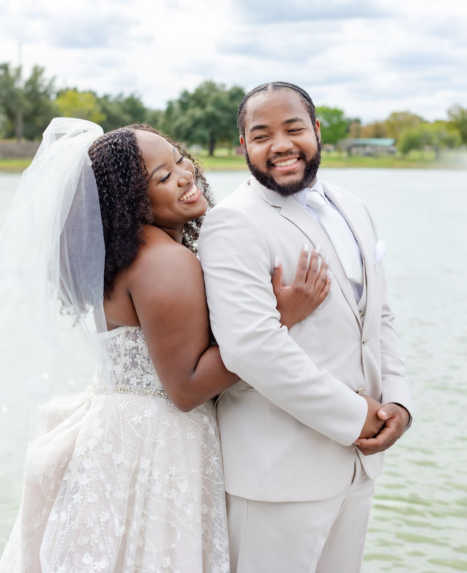 Joyful waterfront wedding photoshoot capturing romantic moments by a scenic lake.