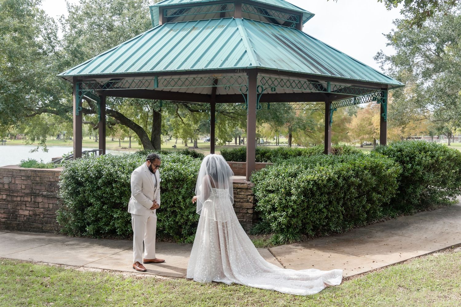 Beautiful outdoor wedding photography setup with green trees and paths in park setting.