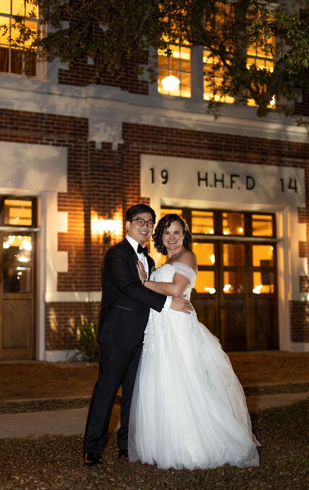 A romantic evening wedding photo sequence shows a couple dancing together outside a brick building with illuminated windows.
