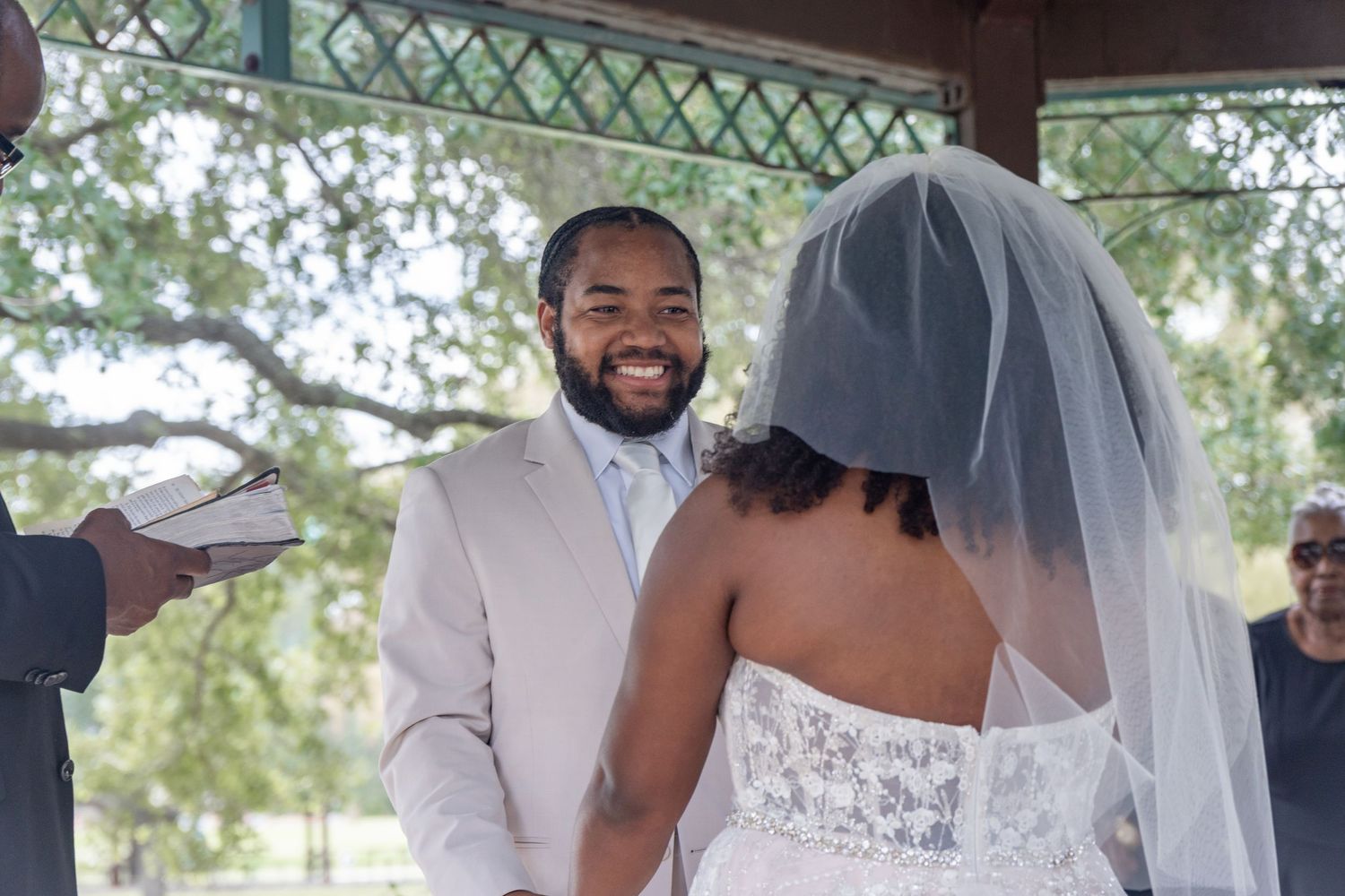 A wedding couple shares their first dance under a covered outdoor pavilion during their special celebration.