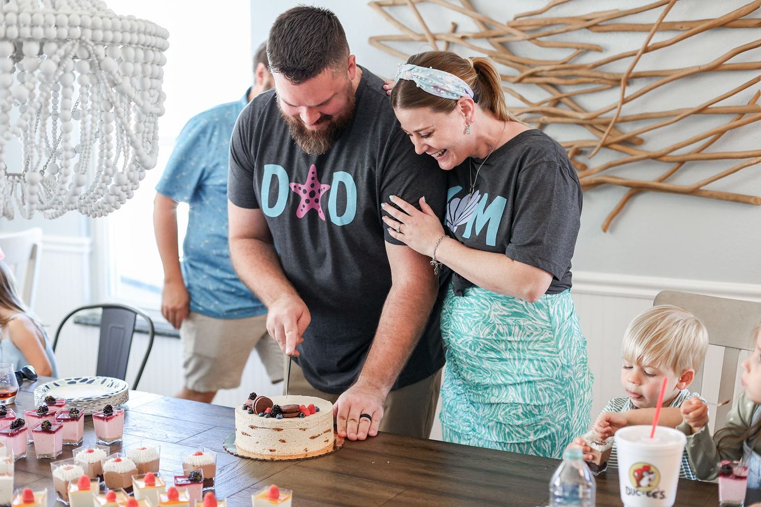 A sequence of photos showing a cake being decorated with pink and white frosting details and floral accents.