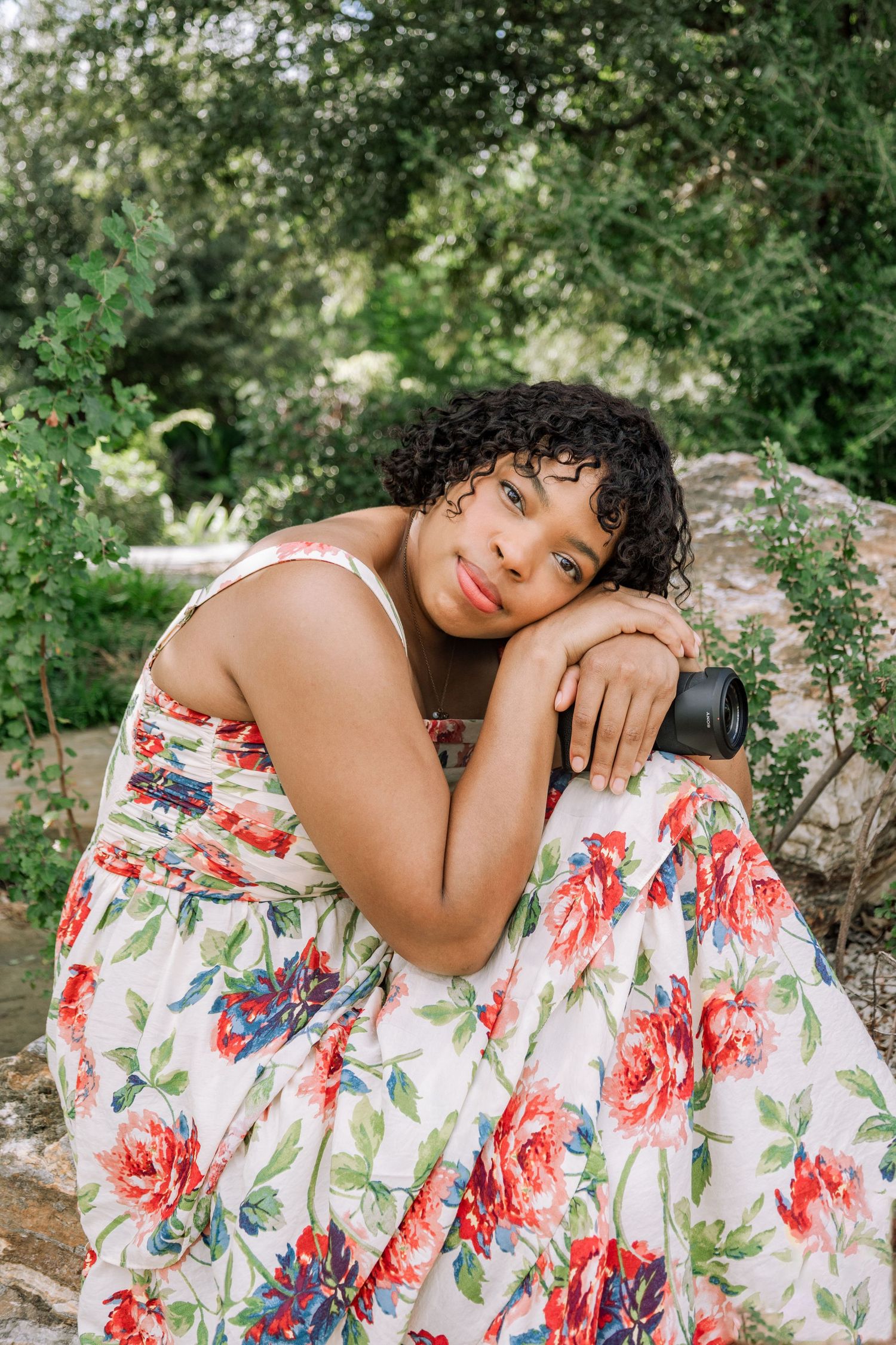 A floral sundress photoshoot in a garden setting with soft natural lighting and artistic poses.