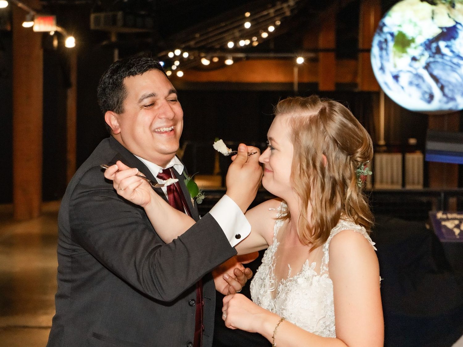 Bride and groom sharing a joyful moment during their first dance at wedding reception.