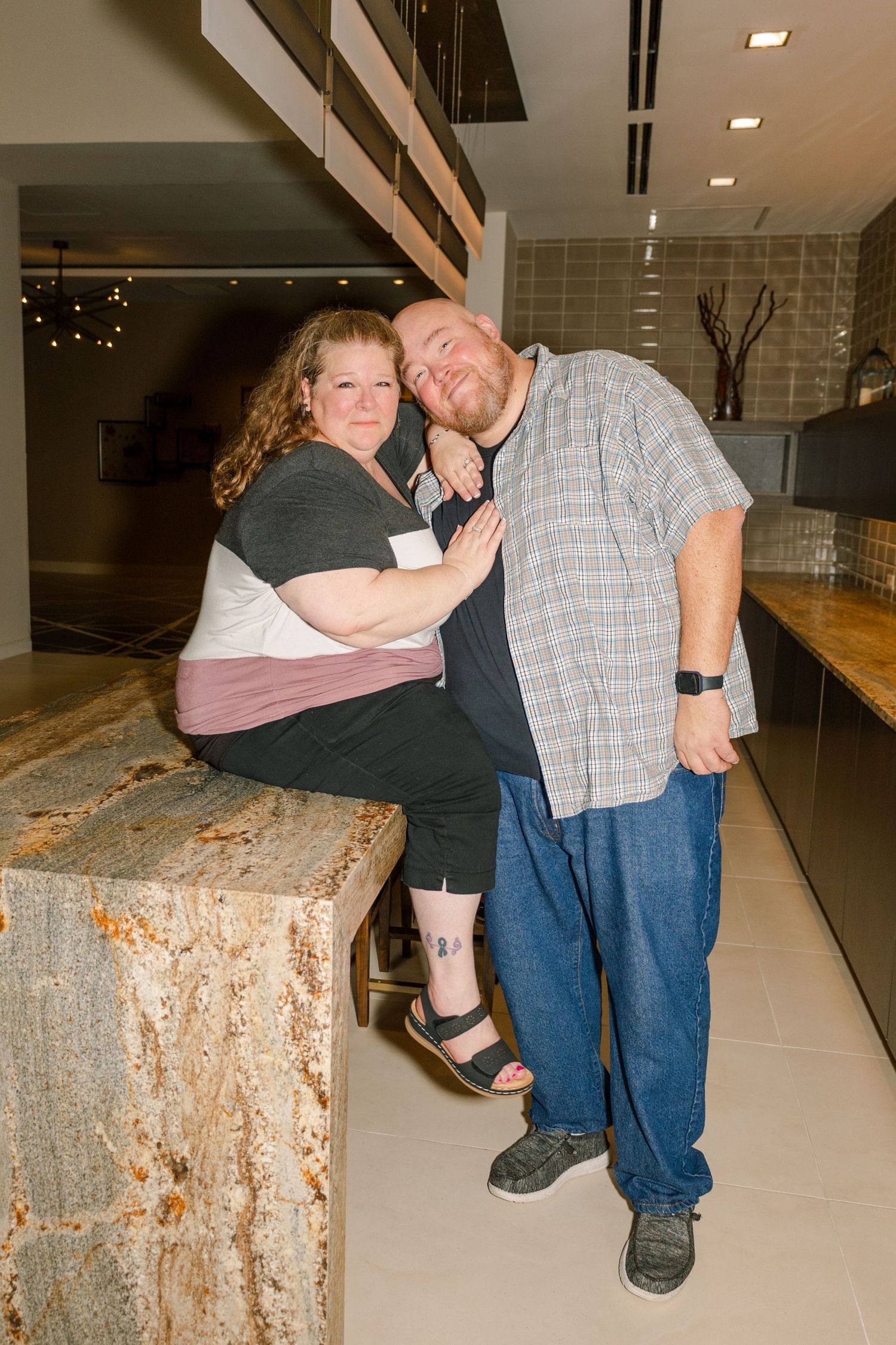 Candid series of a couple sharing playful moments on a stone ledge indoors.