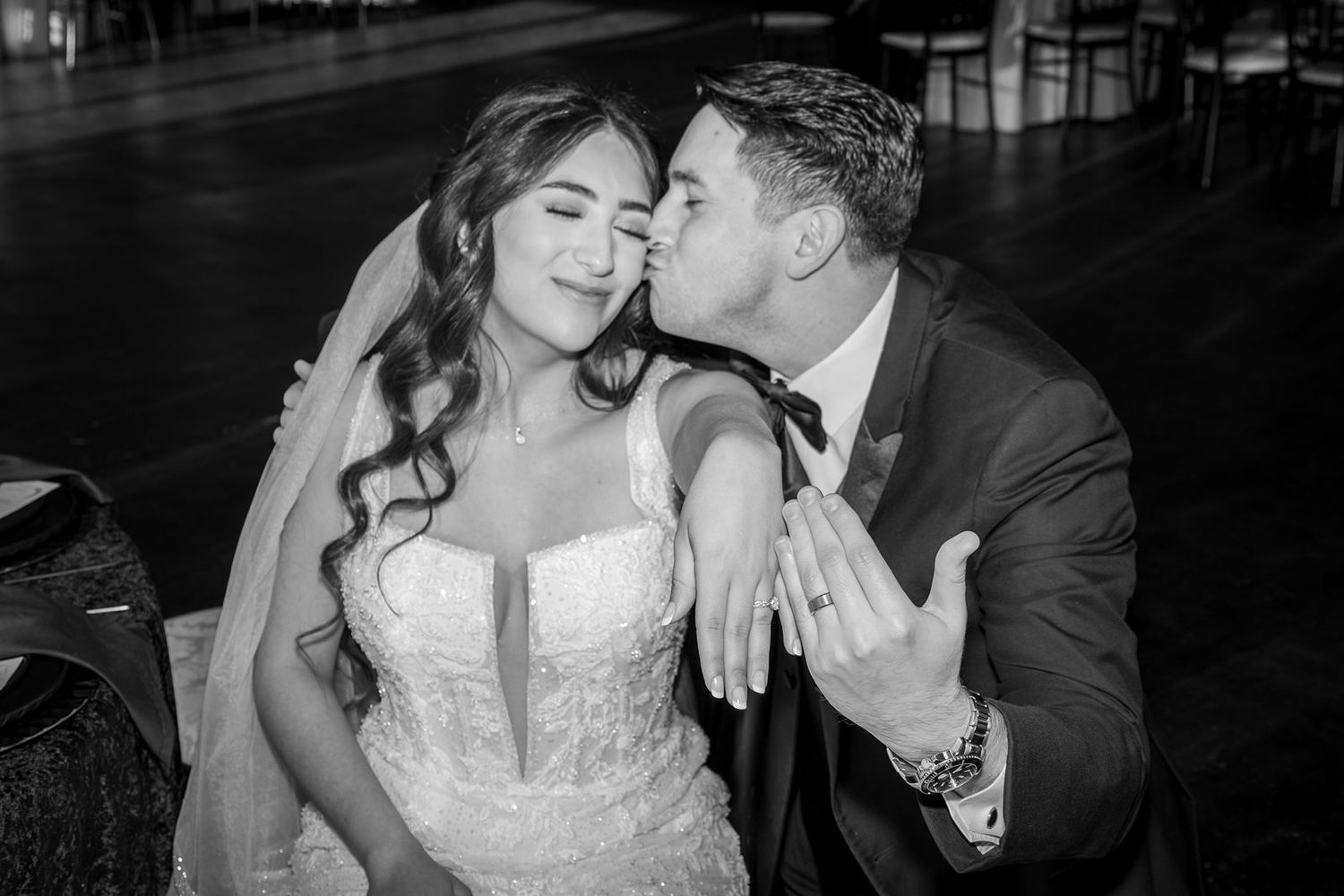 A romantic black and white photo series showing tender moments between a couple on their wedding day.