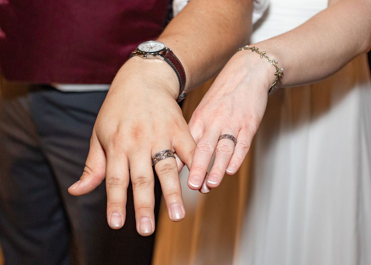 A series of hands displaying engagement and wedding rings in different poses and lighting conditions.