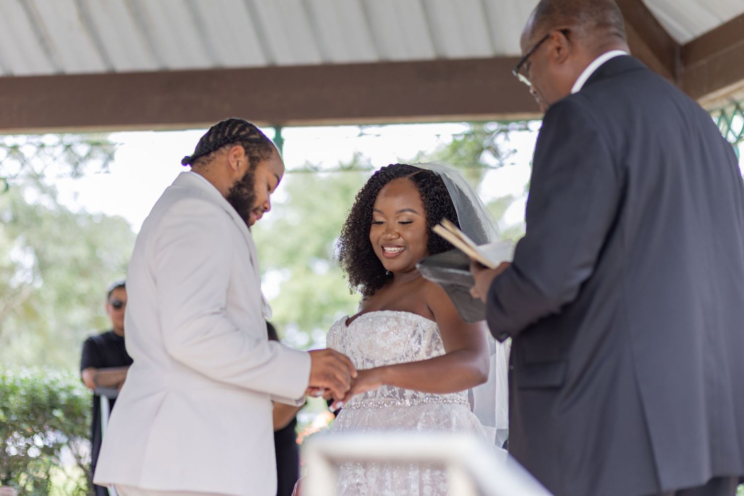 Wedding ceremony guests gather under a covered outdoor venue during a celebration.