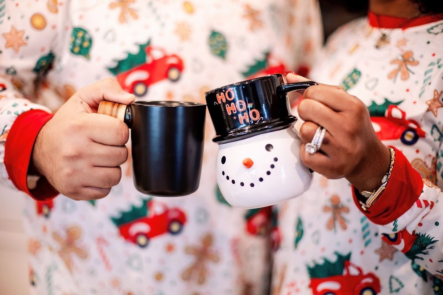 A close-up view of festive red truck patterned Christmas pajamas with decorative holiday designs.