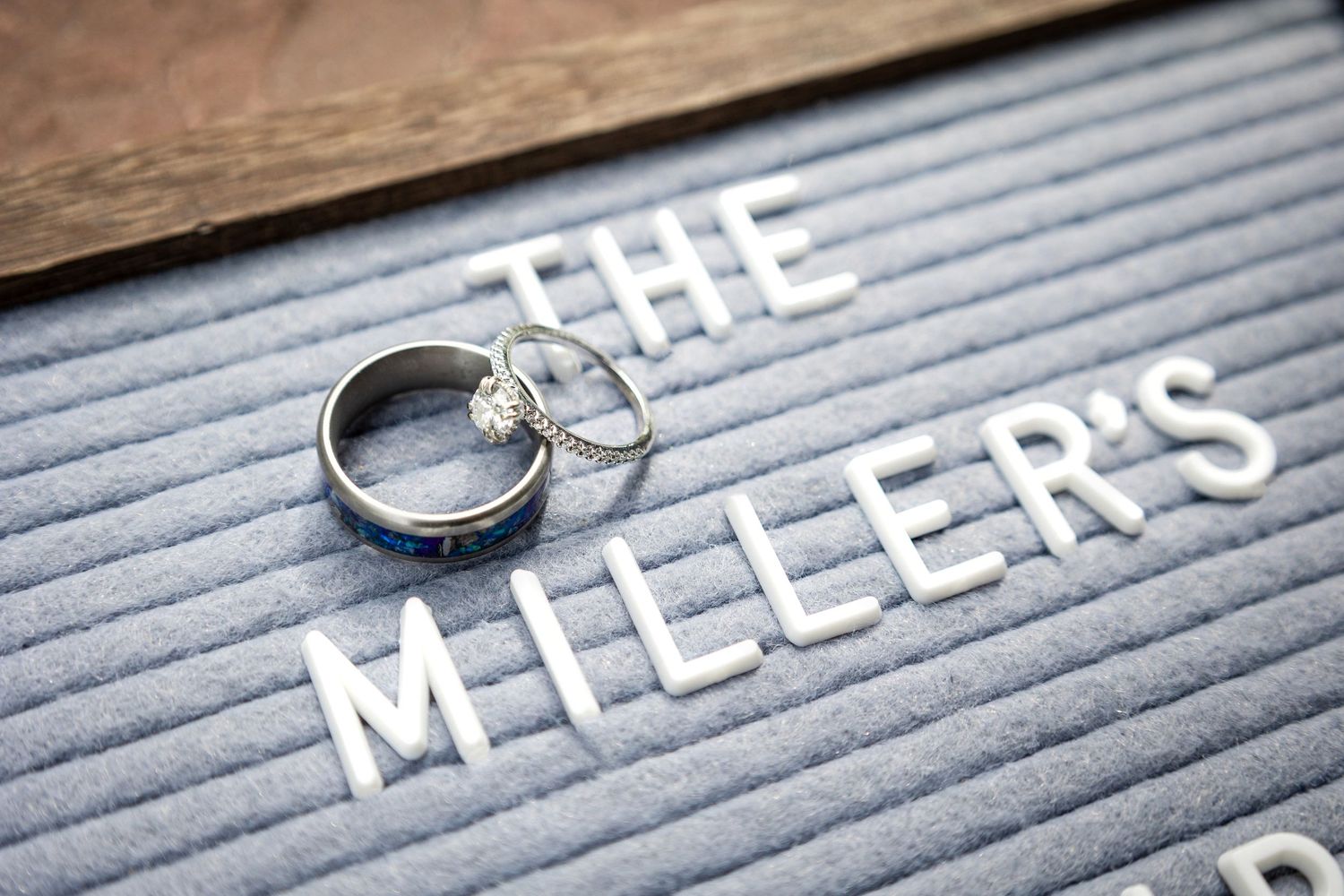 Collection of silver rings displayed on a gray letter board spelling out a partial text message.