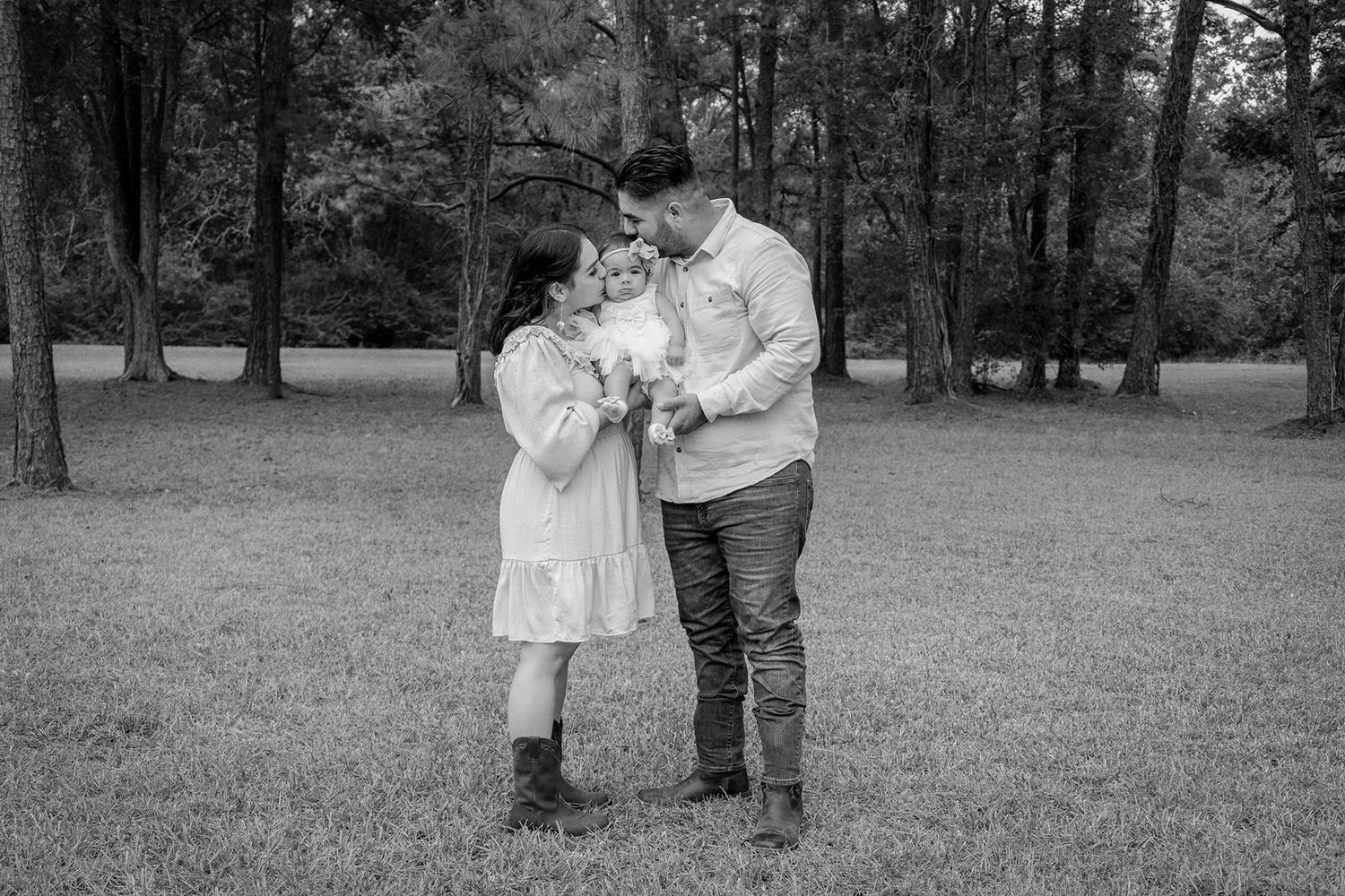 A black and white photo series showing a couple walking and embracing in a park setting.