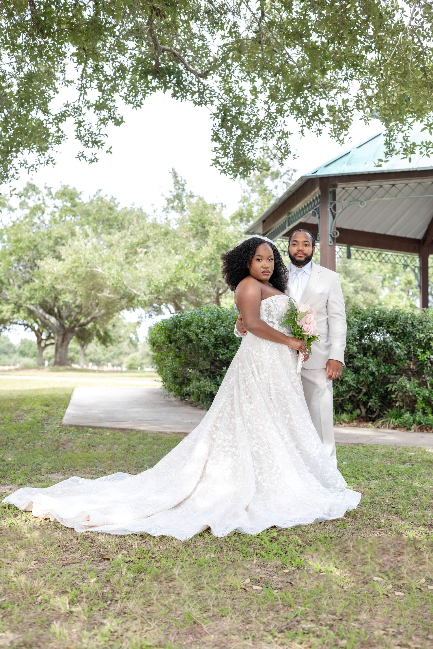 Beautiful wedding photograph series showing couple posing gracefully on grassy outdoor grounds.