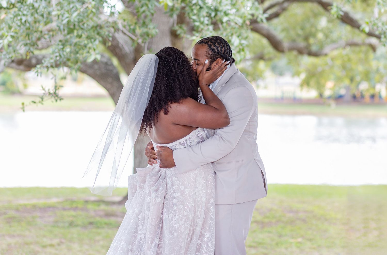 Intimate wedding moments captured under blooming trees with natural sunlight filtering through.