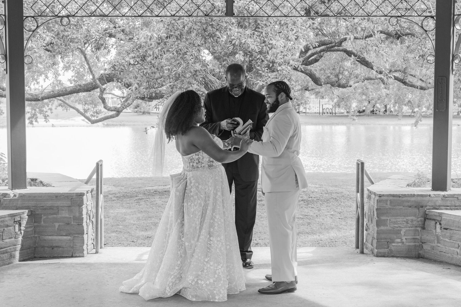 Black and white wedding photos showing celebratory moments under a covered pavilion.