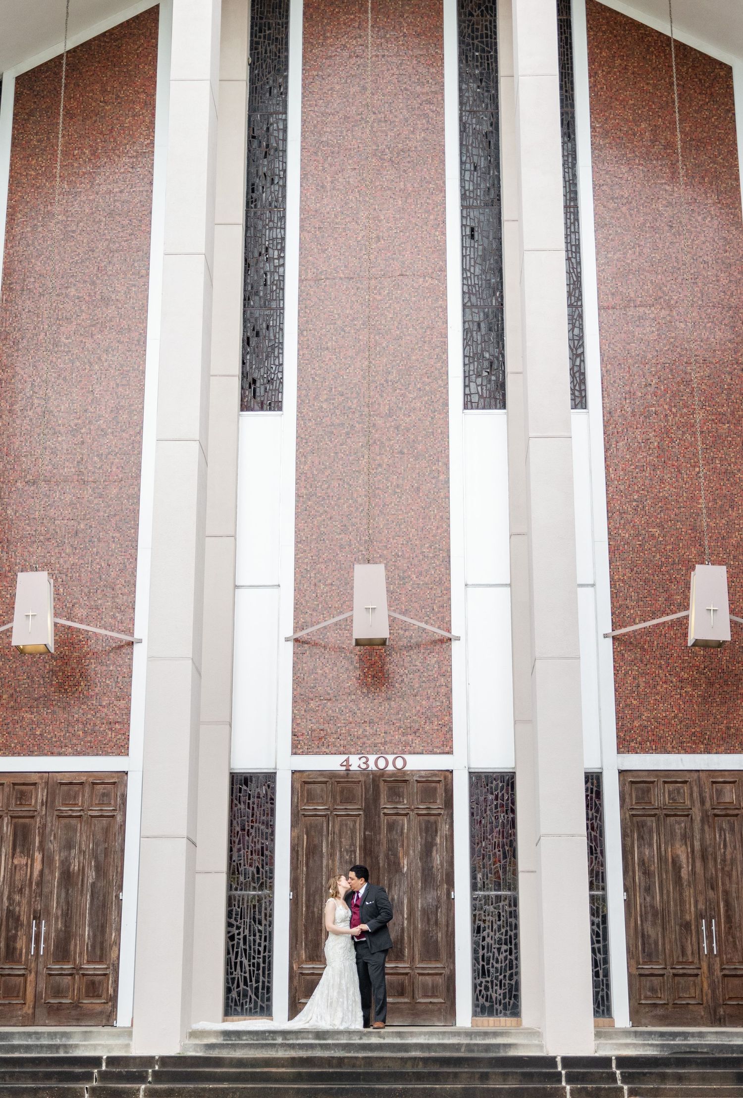 Artistic architectural shot of modern church interior with dramatic lighting and wooden doors.