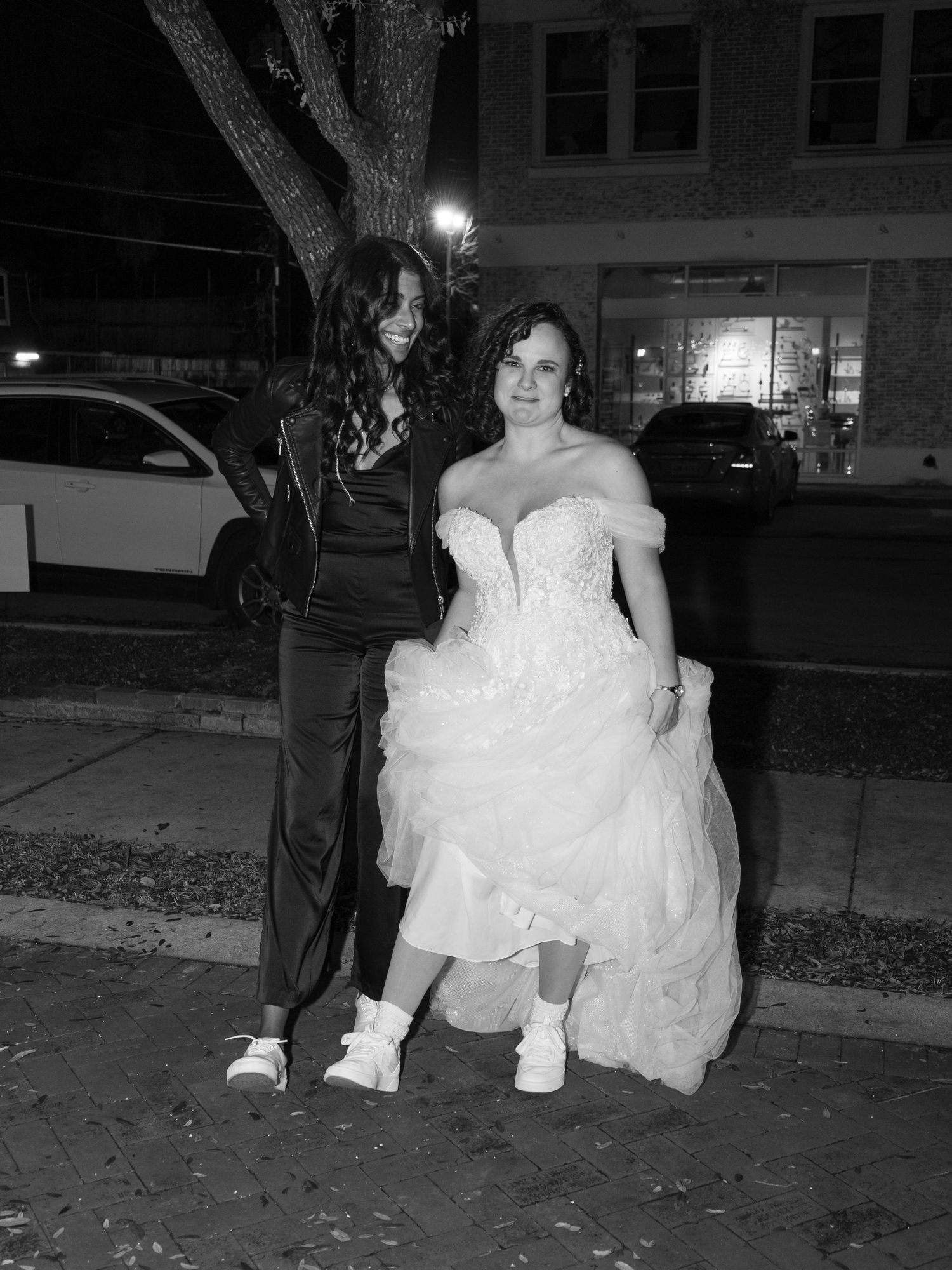 Black and white nighttime portrait of wedding party members outdoors.