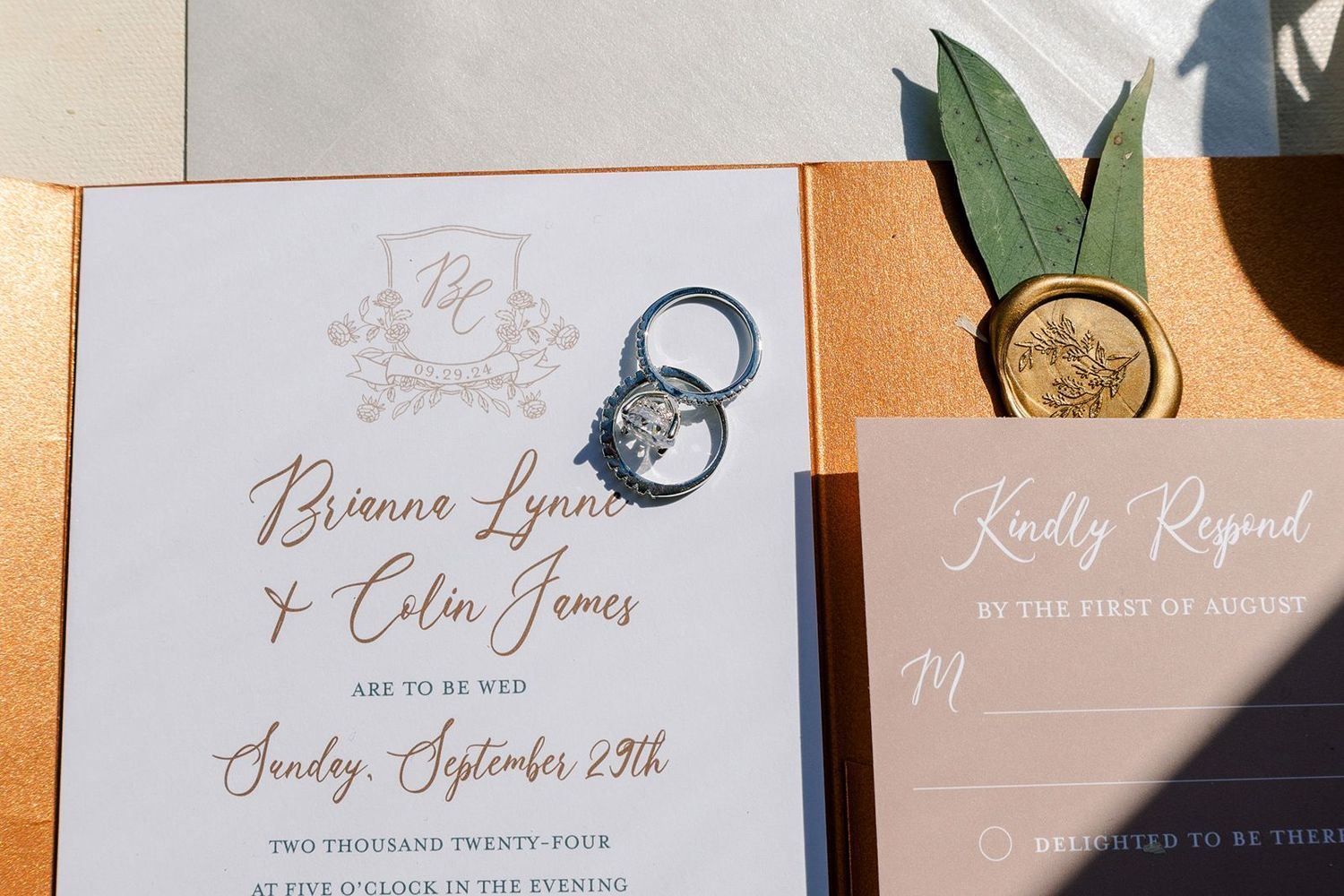 Close-up view of elegant wedding invitation suite with calligraphy text and neutral color palette.