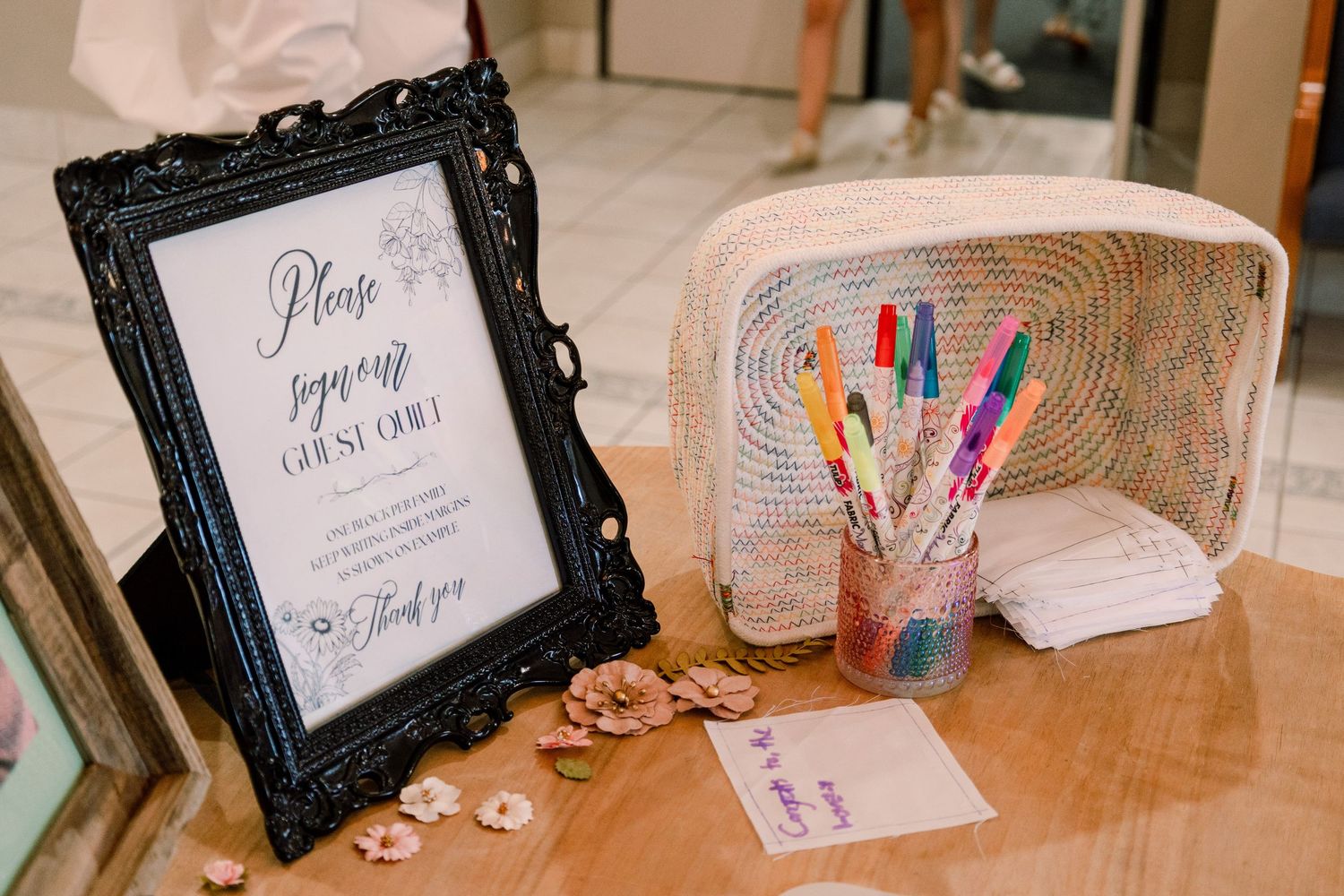 Decorative black frames and craft supplies arranged on a table for an event.