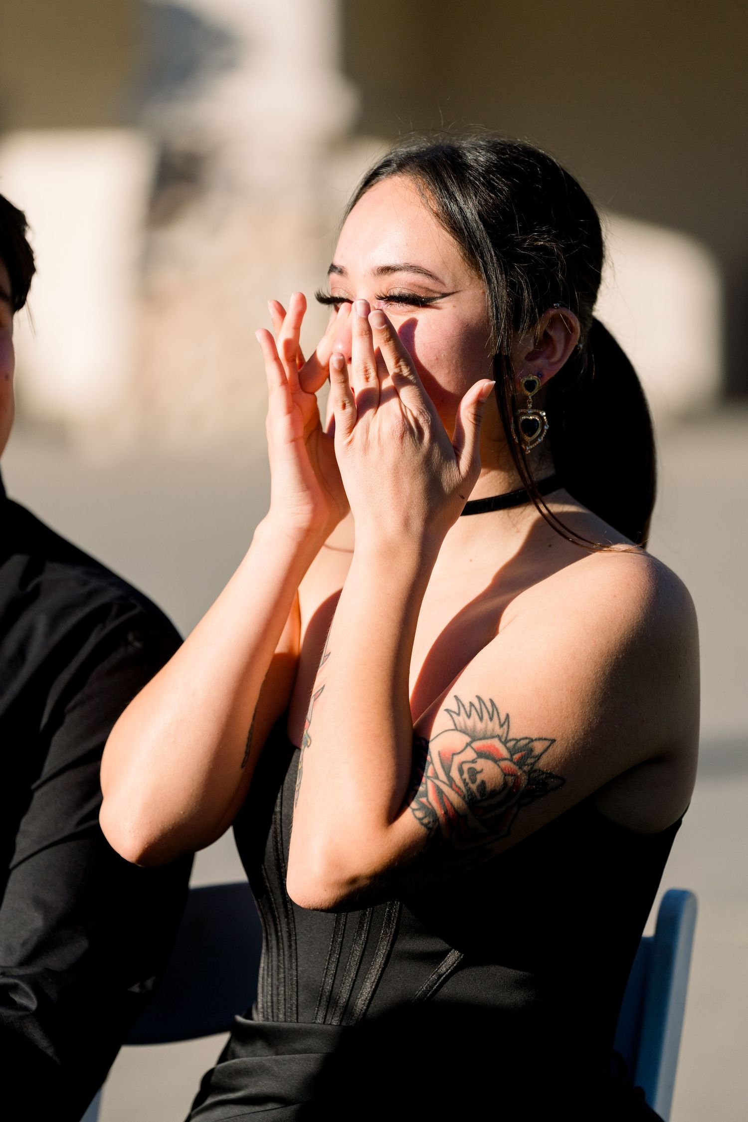 Emotional wedding guest in black dress showing strong reaction during ceremony.