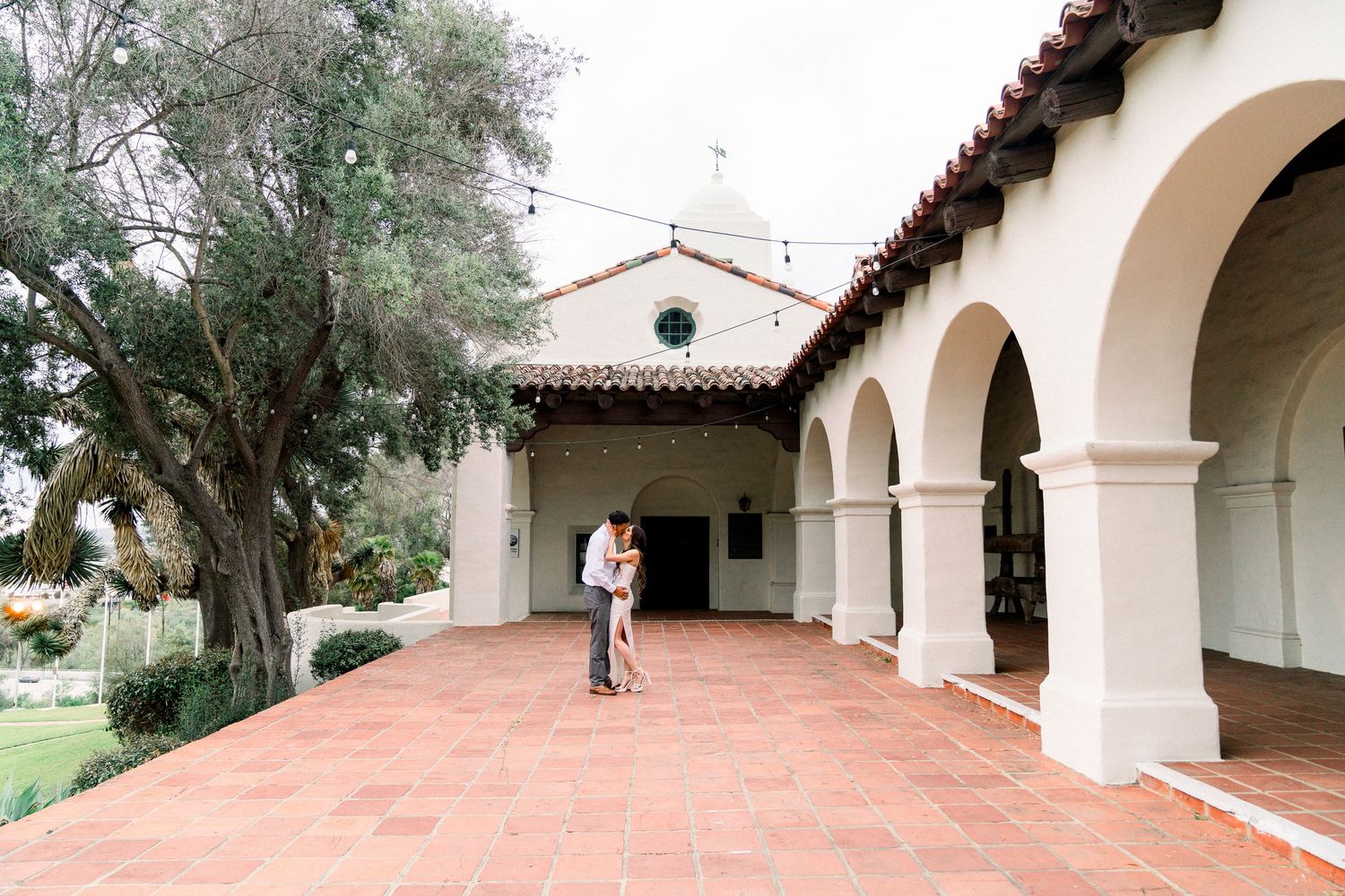 Couple Kissing or Engagement Photos at Junipero SErra Museum with Spanish architecture