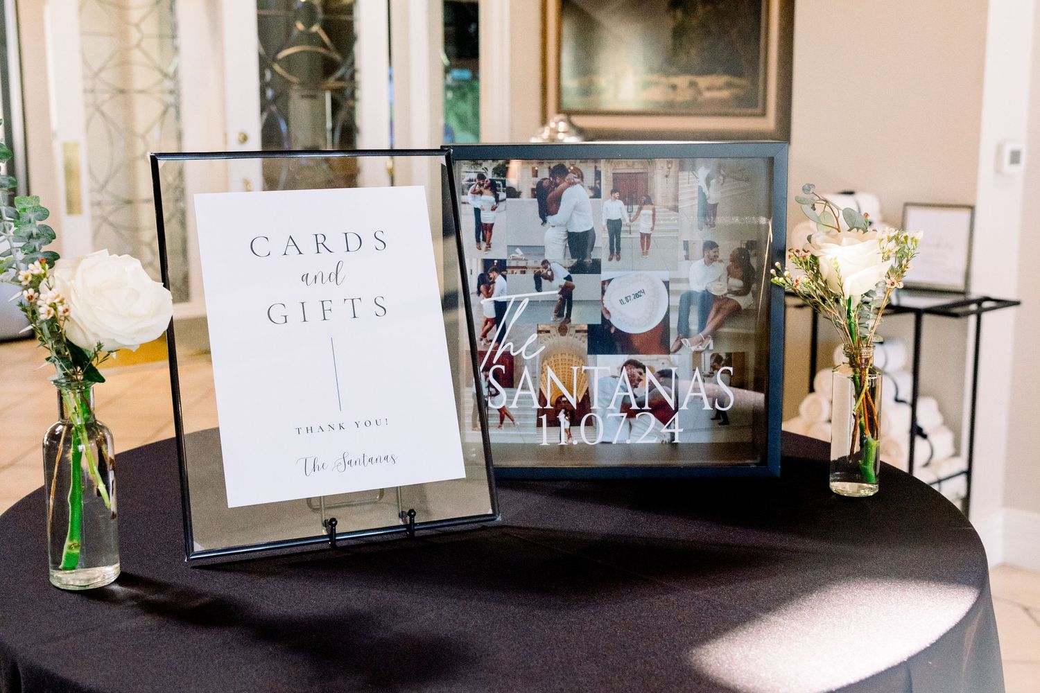 Wedding cards and gifts table with photo display and floral decorations.
