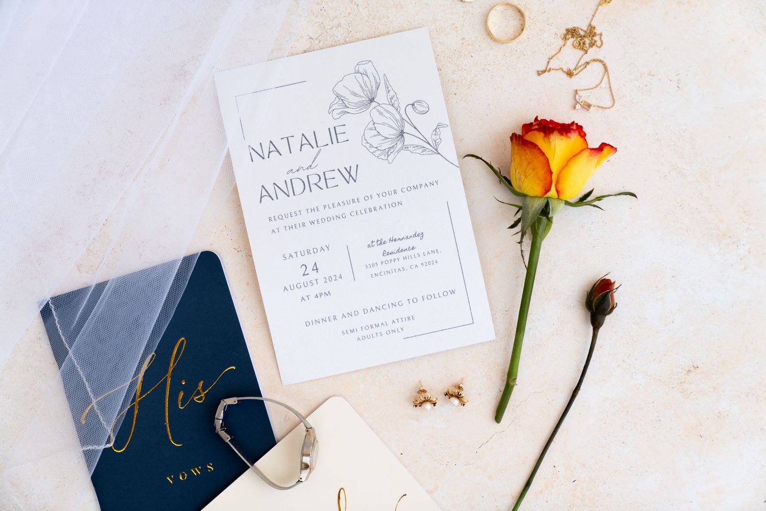 Elegant wedding invitation with marble vow book, orange rose, and delicate gold rings on light textured background.