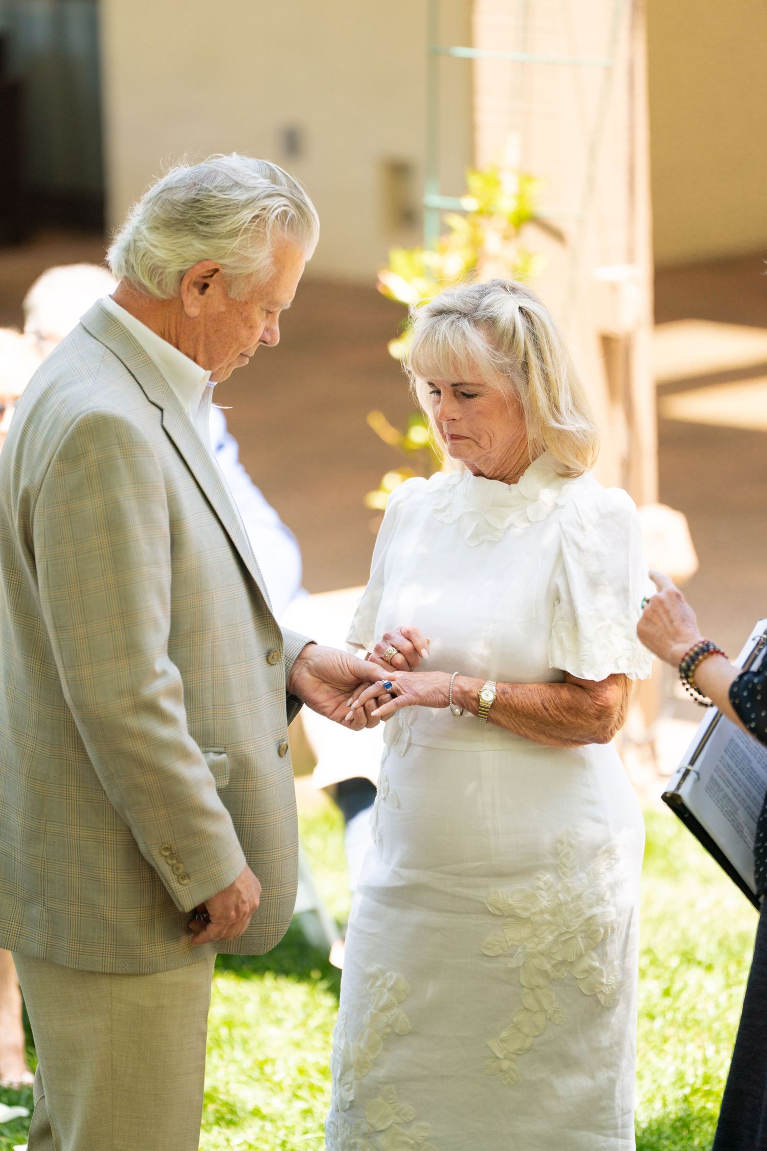 A couple sharing an intimate moment during their outdoor wedding ceremony.